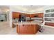 Kitchen with granite countertops, wood cabinets, and barstool seating at 5383 Firethorn Pt, Spring Hill, FL 34609