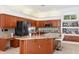 Well appointed kitchen with custom cabinets, granite countertops and stainless appliances at 5383 Firethorn Pt, Spring Hill, FL 34609