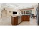 Spacious kitchen island with sink and stainless steel appliances and seating at 5383 Firethorn Pt, Spring Hill, FL 34609