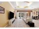Living room with view of the pool and outdoor space, with a neutral color palette at 5383 Firethorn Pt, Spring Hill, FL 34609