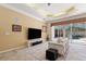 Bright living room with a large rug and view of the pool through sliding glass doors at 5383 Firethorn Pt, Spring Hill, FL 34609