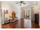 Living room with hardwood floors, a ceiling fan, and sliding glass doors to patio at 5383 Firethorn Pt, Spring Hill, FL 34609