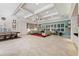 A large living room features tile floors, plantation shutters, and a decorative tray ceiling at 5383 Firethorn Pt, Spring Hill, FL 34609