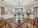 A view of the clubhouse lobby with a chandelier, circular table with flowers, and tiled floor at 5383 Firethorn Pt, Spring Hill, FL 34609