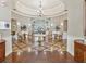 The clubhouse lobby features wood floors, elegant seating, round tables, and decorative wall accents at 5383 Firethorn Pt, Spring Hill, FL 34609