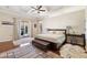 A bright main bedroom with access to the screened pool deck at 5383 Firethorn Pt, Spring Hill, FL 34609