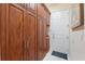Mud room with ample cherry cabinets and a door to the exterior at 5383 Firethorn Pt, Spring Hill, FL 34609