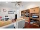 Office space with hardwood floors, built-in shelving, and desk, providing functional and decorative storage at 5383 Firethorn Pt, Spring Hill, FL 34609