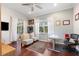 Well-lit office area with hardwood flooring, a decorative rug, and windows providing natural light at 5383 Firethorn Pt, Spring Hill, FL 34609