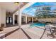 The screened pool area features an in-ground pool and spa and plenty of room for entertaining at 5383 Firethorn Pt, Spring Hill, FL 34609