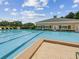 Large swimming pool with marked lanes and a sun deck, perfect for recreation and relaxation at 5383 Firethorn Pt, Spring Hill, FL 34609