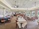 A clubhouse restaurant with tables and chairs, bar, and views to the exterior at 5383 Firethorn Pt, Spring Hill, FL 34609