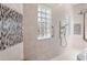A custom tile detail and shower in the bathroom at 5383 Firethorn Pt, Spring Hill, FL 34609
