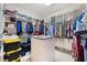 Large walk-in closet with built-in shelving, drawers, and central island provides ample storage space at 5383 Firethorn Pt, Spring Hill, FL 34609