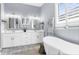 Bright bathroom with double vanities, soaking tub, and elegant fixtures, offering a spa-like experience at 5731 Summit View Dr, Brooksville, FL 34601