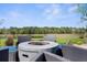 Outdoor fire pit surrounded by wicker chairs, offering beautiful views of the lake and surrounding landscape at 5731 Summit View Dr, Brooksville, FL 34601