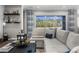Bright and airy living room with a large window offering scenic views, complemented by stylish decor and a comfortable sofa at 5731 Summit View Dr, Brooksville, FL 34601