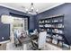 Bright office space featuring bold blue walls, ample shelving, and a chandelier at 5731 Summit View Dr, Brooksville, FL 34601