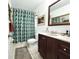 Bathroom featuring a dark wood vanity, neutral wall color, and shower and tub combination at 5801 65Th N Ter, Pinellas Park, FL 33781