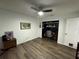 Bedroom with hardwood floors, fan, closet office, and white walls at 5801 65Th N Ter, Pinellas Park, FL 33781