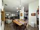 Well-lit dining area featuring modern lighting and a view of the living room and kitchen at 5801 65Th N Ter, Pinellas Park, FL 33781