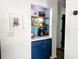 Dry bar features updated cabinets, sleek shelving, and a bright blue accent wall at 5801 65Th N Ter, Pinellas Park, FL 33781