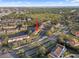 An aerial view shows the condo's proximity to a pond, tennis court, and local roadways at 6027 Bayside Key Dr, Tampa, FL 33615