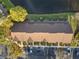 A condo roof viewed from above is surrounded by landscaping, a parking lot, and a pond at 6027 Bayside Key Dr, Tampa, FL 33615