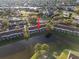 Aerial view of a waterfront condo features a pond, trees, and a glimpse of community amenities at 6027 Bayside Key Dr, Tampa, FL 33615