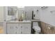 Bathroom with double sinks, white cabinets, and tiled floors at 6027 Bayside Key Dr, Tampa, FL 33615