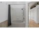 Bathroom featuring a combined tub and shower with tiled walls at 6027 Bayside Key Dr, Tampa, FL 33615