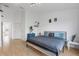 Modern bedroom with a minimalist design, featuring a large window and wood floors at 6027 Bayside Key Dr, Tampa, FL 33615
