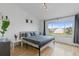 Bright bedroom featuring wood floors, large windows, and modern minimalist decor at 6027 Bayside Key Dr, Tampa, FL 33615
