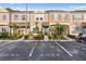 Charming townhouse with colorful facade, manicured landscaping, and dedicated parking spot at 6027 Bayside Key Dr, Tampa, FL 33615