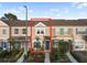 Townhome featuring a well-maintained facade and landscaped front yard at 6027 Bayside Key Dr, Tampa, FL 33615