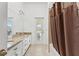 Bathroom with dual vanity, granite countertop, and shower-tub combination with natural light at 6413 Emerson Rd, Brooksville, FL 34601