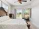 Bright bedroom features slider to backyard and ceiling fan at 6413 Emerson Rd, Brooksville, FL 34601
