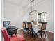 Elegant dining room with hardwood floors and a stylish chandelier above table setting at 6413 Emerson Rd, Brooksville, FL 34601