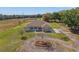 Inviting single-story home features lush landscaping, long driveway, and charming pond view at 6413 Emerson Rd, Brooksville, FL 34601