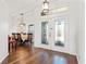 Bright foyer featuring decorative glass doors and hardwood floors leading to dining area at 6413 Emerson Rd, Brooksville, FL 34601