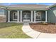 Inviting front entrance with elegant columns and a well-manicured lawn at 6413 Emerson Rd, Brooksville, FL 34601