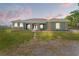 Stately facade with stone accents, stately columns, and a manicured lawn at 6413 Emerson Rd, Brooksville, FL 34601