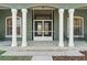 Detailed front porch showcasing white columns and a decorative glass front door at 6413 Emerson Rd, Brooksville, FL 34601