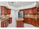 Kitchen with stainless steel appliances, center island and granite counters at 6413 Emerson Rd, Brooksville, FL 34601