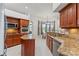 Well-equipped kitchen features granite countertops, stainless steel appliances, and breakfast nook at 6413 Emerson Rd, Brooksville, FL 34601
