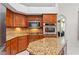 Kitchen boasts stainless appliances, granite countertops and island at 6413 Emerson Rd, Brooksville, FL 34601