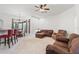 Spacious living room featuring neutral carpet, comfortable brown sofas, and dining area at 6413 Emerson Rd, Brooksville, FL 34601