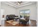 Spacious living room with a tray ceiling and sliding doors to the screened patio at 6413 Emerson Rd, Brooksville, FL 34601