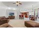 Open-concept living room flows to dining area, featuring neutral carpet and a kitchen bar at 6413 Emerson Rd, Brooksville, FL 34601
