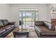 Open-concept living room with hardwood floors leading to a screened-in patio at 6413 Emerson Rd, Brooksville, FL 34601